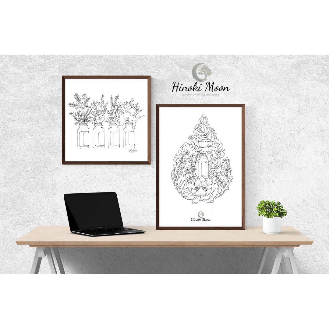 Desk with framed line drawings of flowers and essential oil bottles